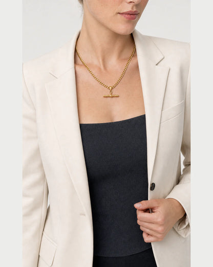 Model holding her blazer lapel while wearing the Sabine curb necklace