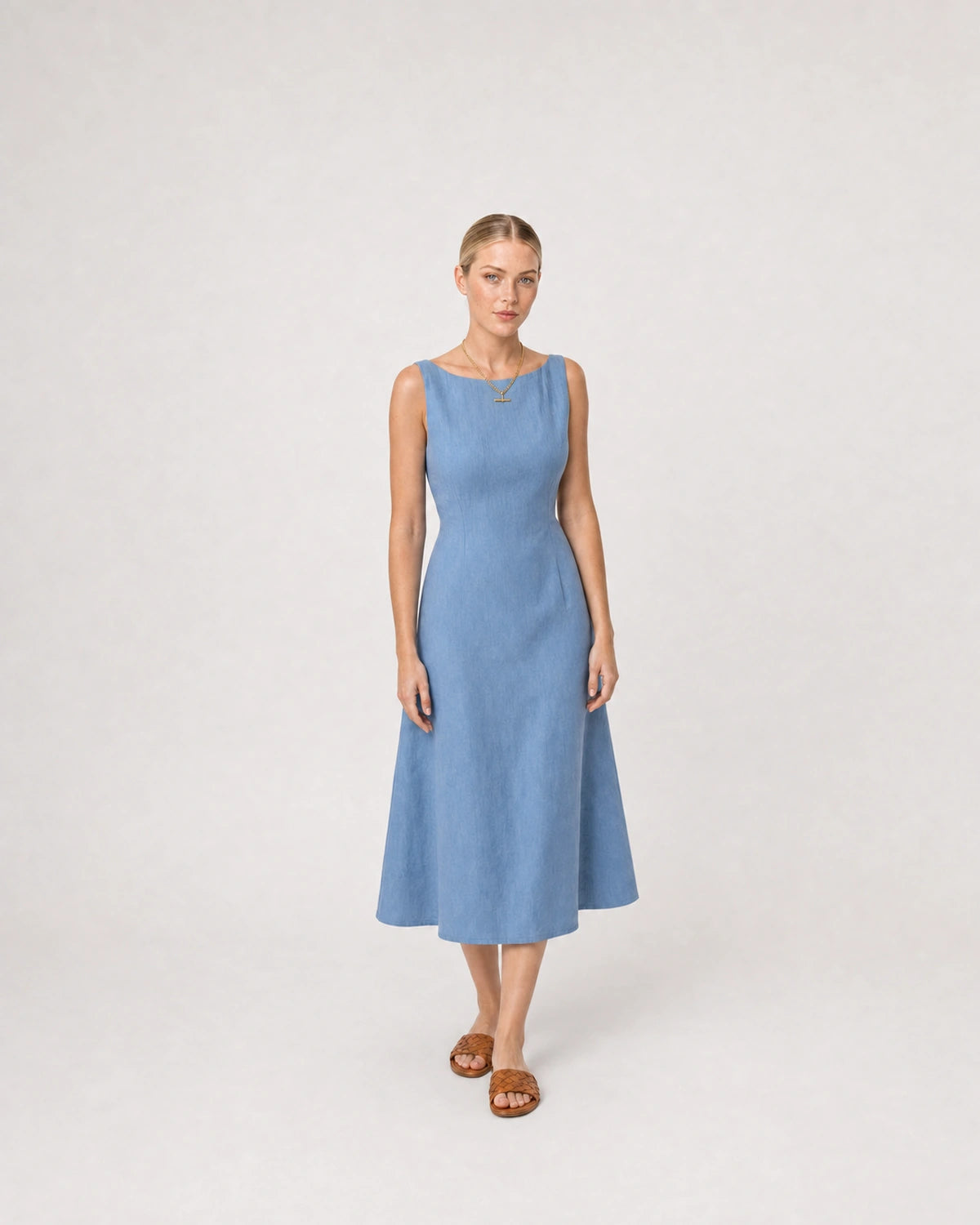 Full-body summer portrait in a blue linen midi dress featuring Sabine