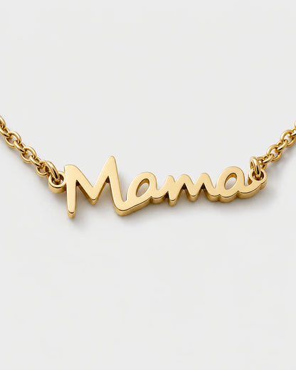 Macro detail of the polished connected Mama script and fine gold chain