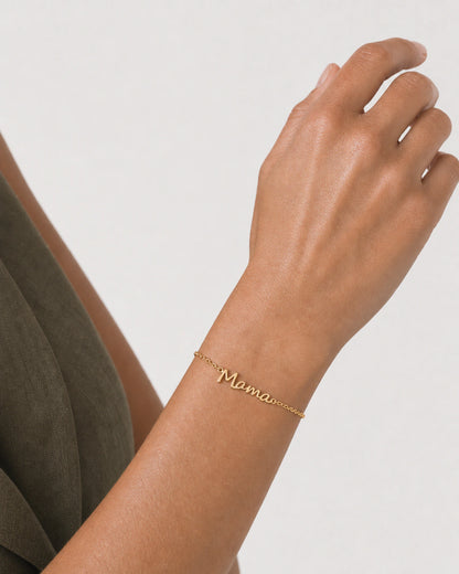 Close wearing view of the polished gold Sera Script Mama Bracelet