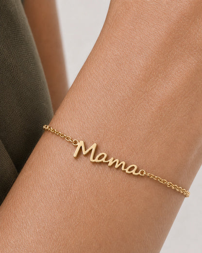 Extreme on-wrist macro of the Sera gold Mama script and fine chain