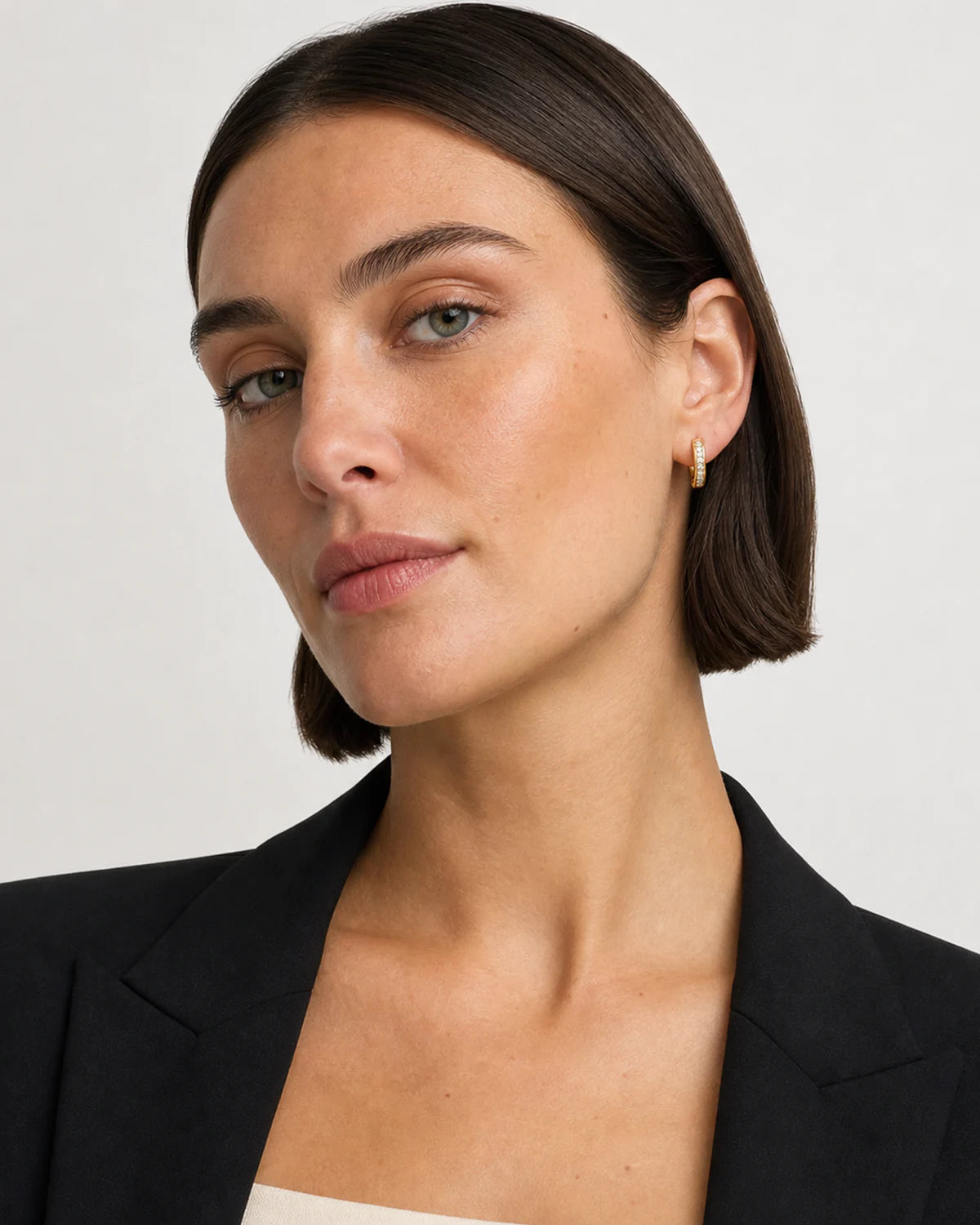 British model in black tailoring wearing Serein pave huggies
