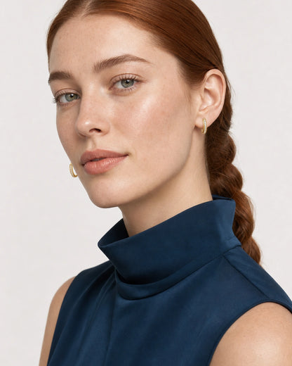 Face portrait wearing the Serein gold single-row pavé huggies