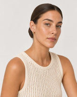 Model in an ivory crochet summer shell wearing Serein single-row pave huggies