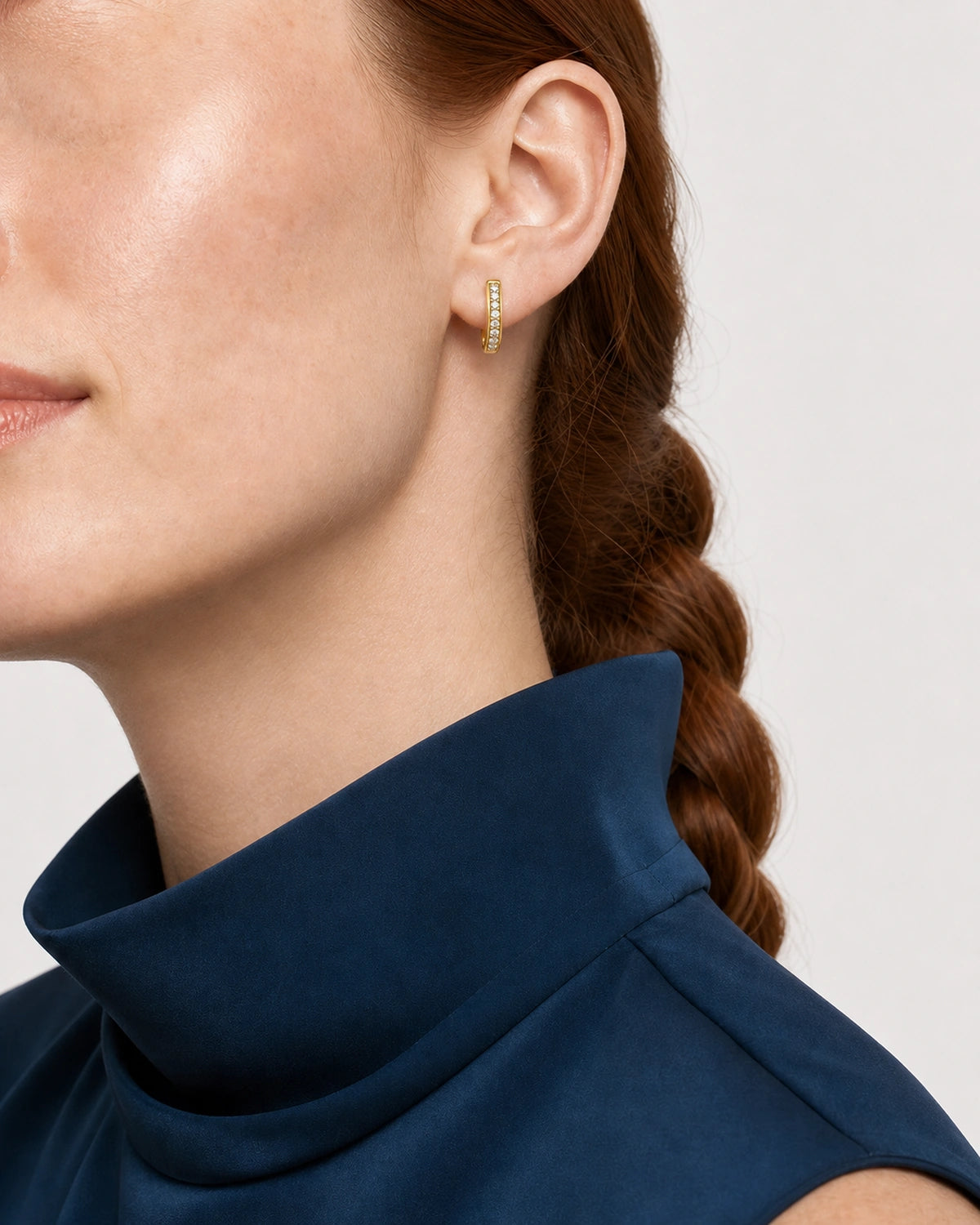 Alternate left-ear and lower-face view of the Serein gold pavé huggie