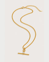 Sloane gold-tone toggle necklace in an alternate curved arrangement on pale grey