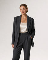 Wide grey-studio editorial portrait featuring the Sloane toggle necklace