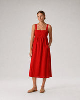 Full-body red sundress portrait featuring the Sloane crystal toggle necklace