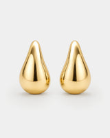 Solène gold sculpted teardrop stud earrings on pale dove-grey