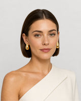 Australian model wearing the Solène gold teardrop stud earrings