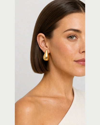 Close side portrait showing the Solène gold teardrop stud