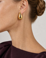 Eye-free left profile of Lydia wearing the gold Solène teardrop earring