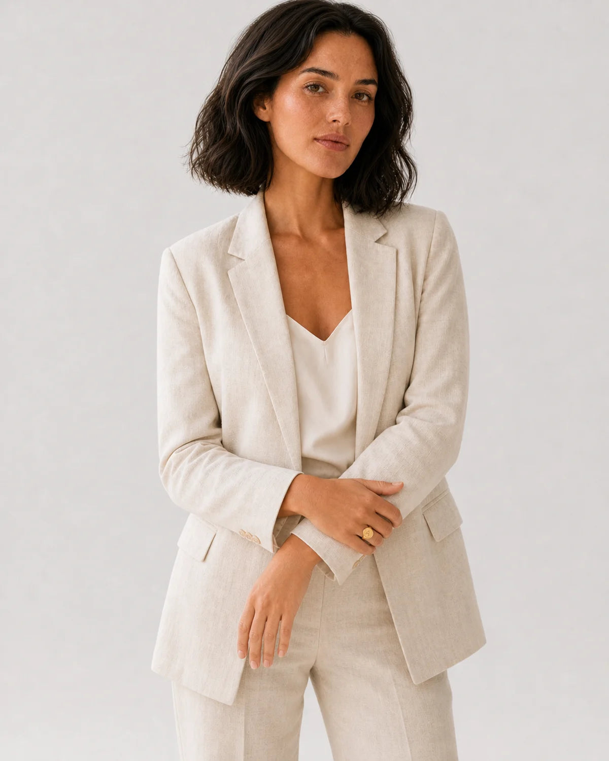Wide editorial studio portrait showing the Solenne signet ring at natural scale