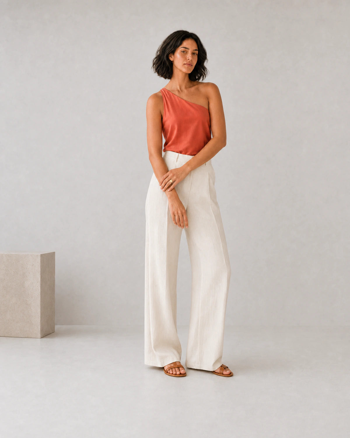 Full-body coral silk and ivory linen portrait featuring the Solenne signet ring