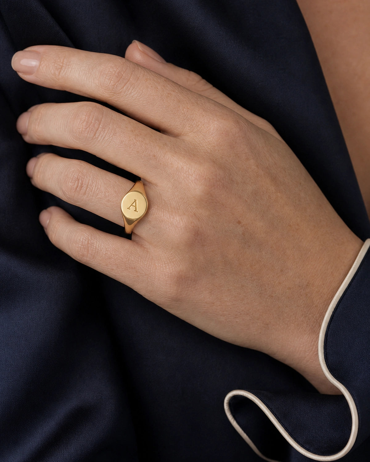 Complete worn macro of the gold Solenne oval initial A signet ring