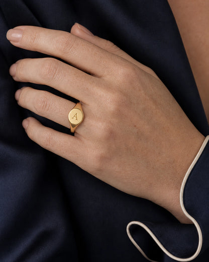 Complete worn macro of the gold Solenne oval initial A signet ring