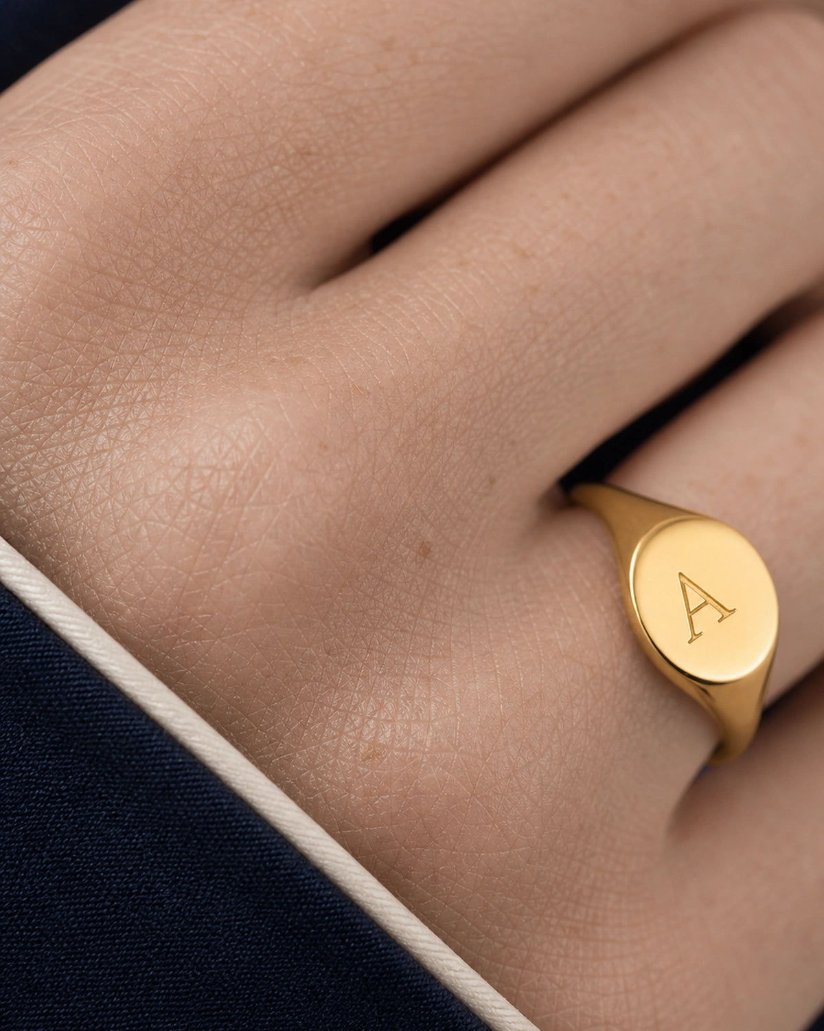 Extreme worn macro of the gold Solenne serif A engraving and shoulder