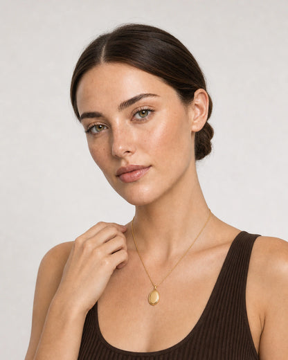 Model in a Lake Como espresso knit dress wearing the Solenne oval pendant necklace