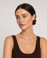 Alternate European-summer portrait featuring the Solenne gold signet pendant