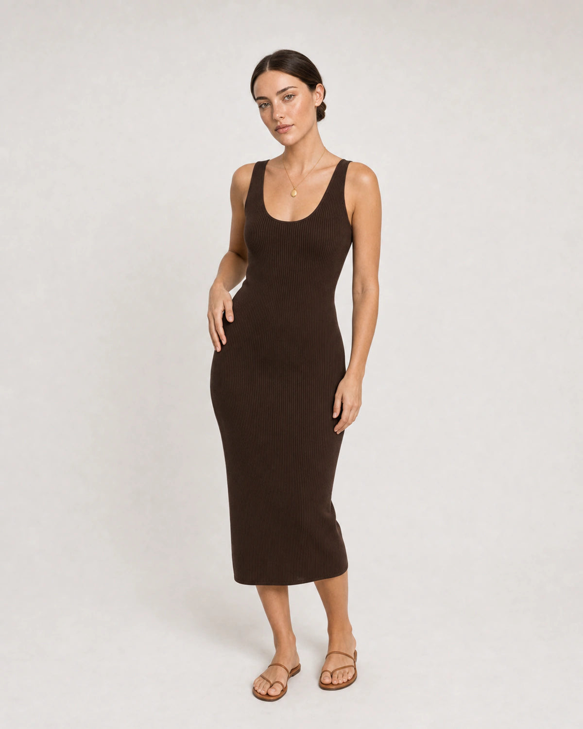 Full-body espresso knit dress portrait featuring the Solenne pendant necklace