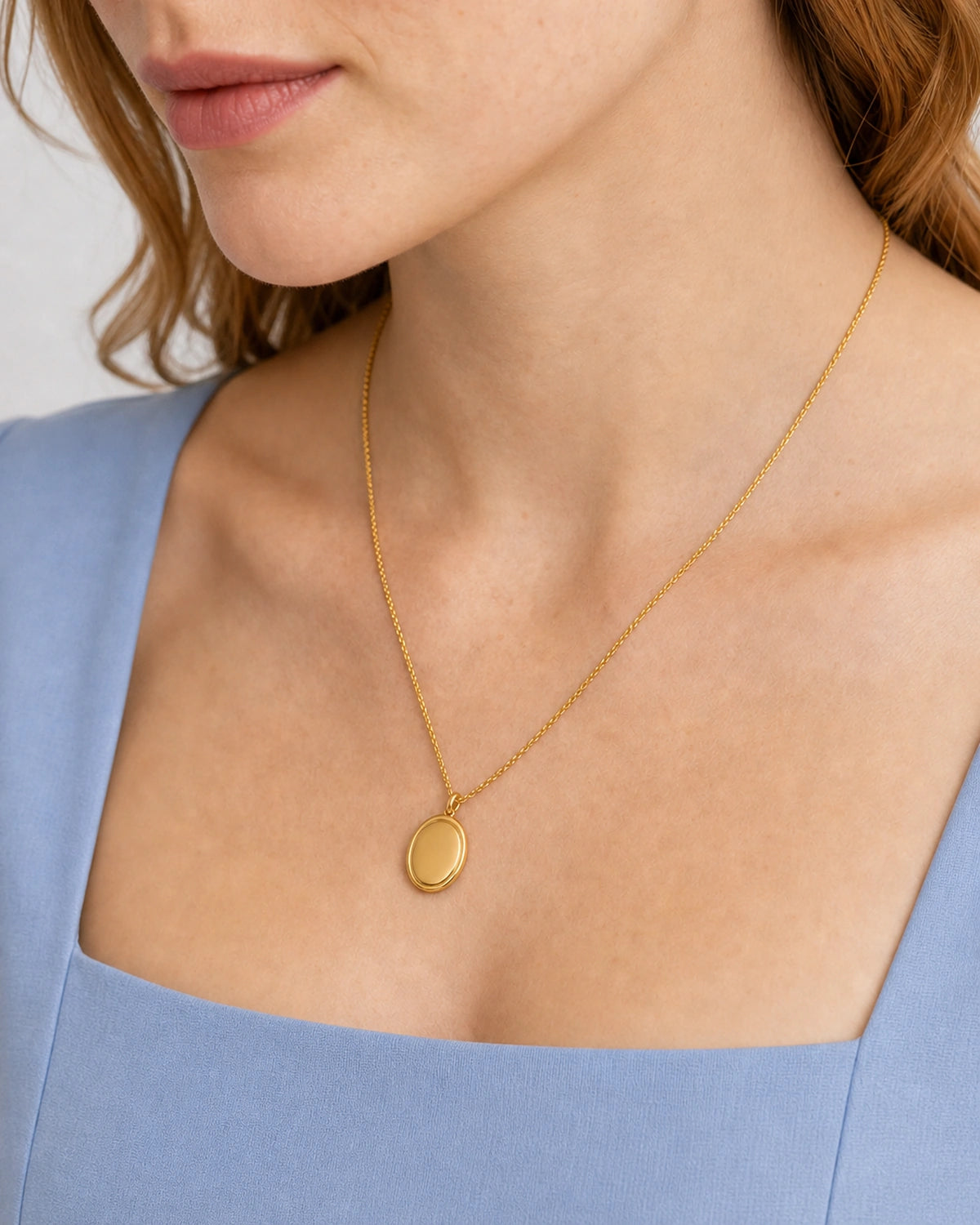 Alternate lower-face wearing view of the gold Solenne signet pendant necklace