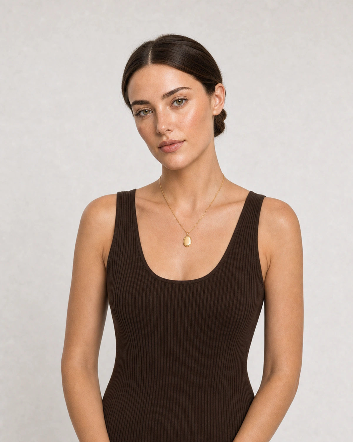 Human-scale portrait showing the Solenne signet pendant necklace