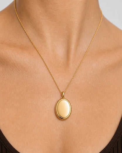Extreme on-body macro of the Solenne blank oval pendant, bail and fine chain
