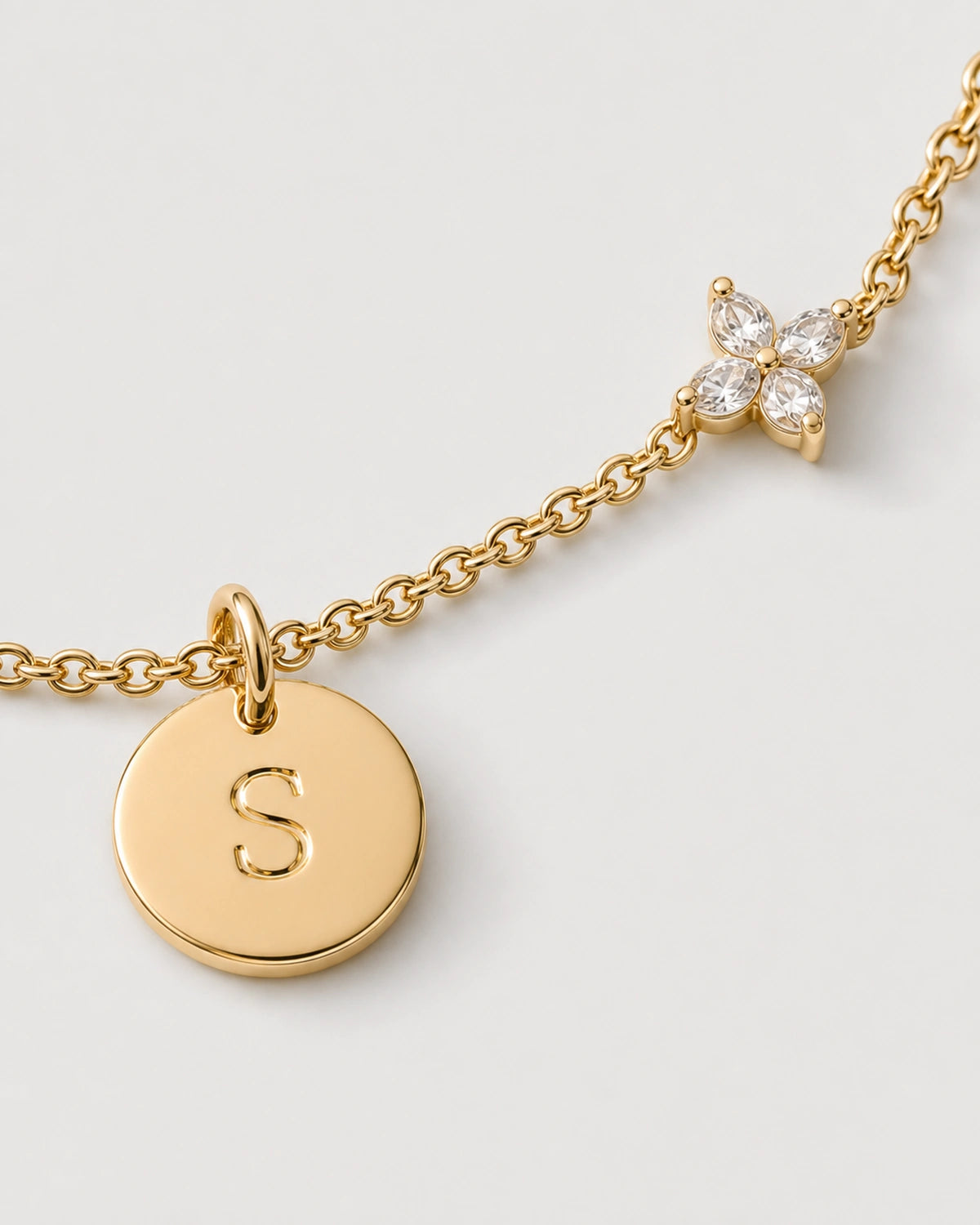 Macro of the gold Soline serif S disc and four-marquise zircon flower