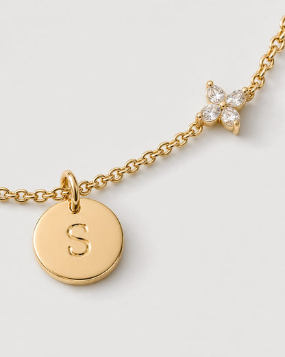 Macro of the gold Soline serif S disc and four-marquise zircon flower