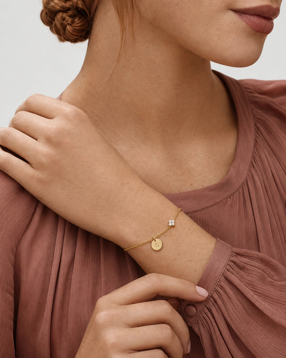 Australian model in smoky rose wearing the gold Soline initial bracelet