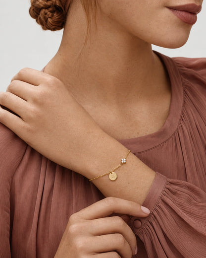 Australian model in smoky rose wearing the gold Soline initial bracelet