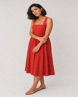 Full-body red poplin summer portrait featuring the Soline initial bracelet