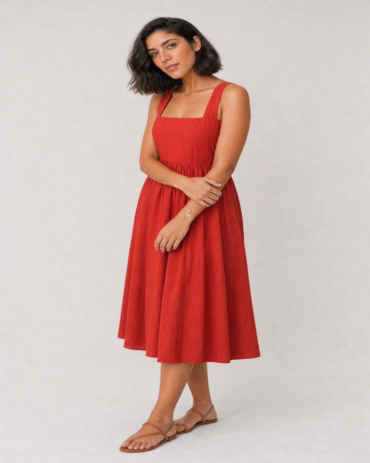 Full-body red poplin summer portrait featuring the Soline initial bracelet