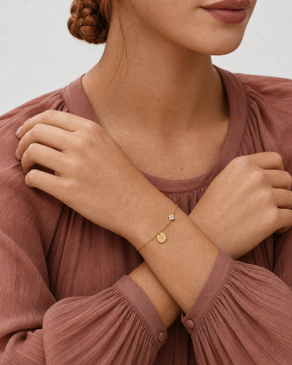 Crossed-wrists pose wearing the gold Soline initial S bracelet
