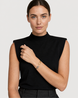 Model in black tailoring wearing the Sora two-tone bangle