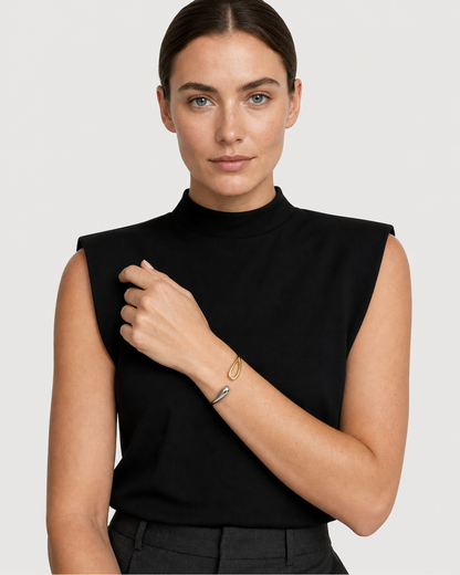 Model in black tailoring wearing the Sora two-tone bangle