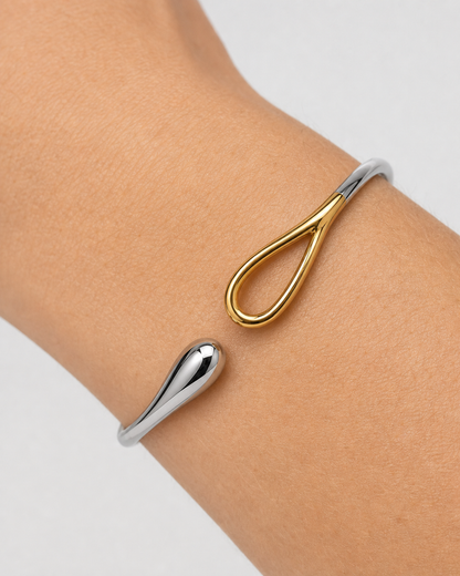 Extreme wrist macro of Sora silver droplet and gold loop terminals