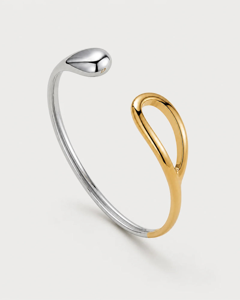 Sora two-tone open bangle on a pale neutral-grey studio background