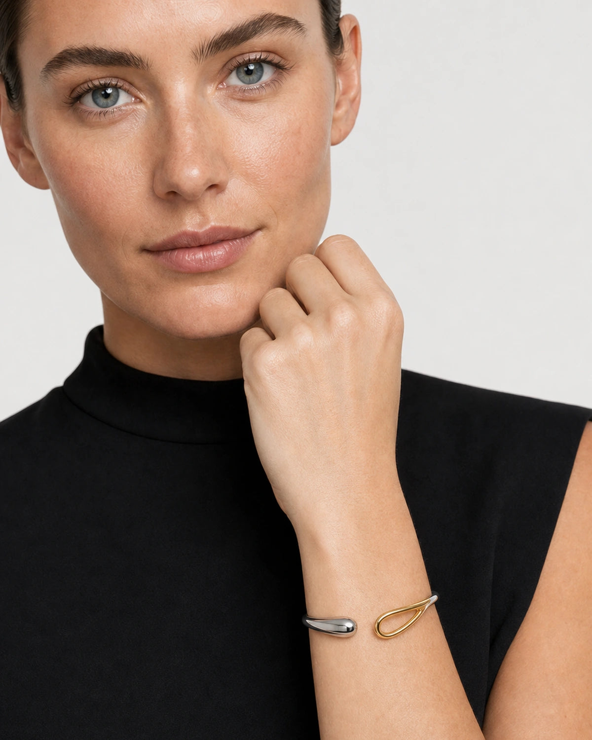 Clean wrist close-up of the Sora mixed-metal open bangle