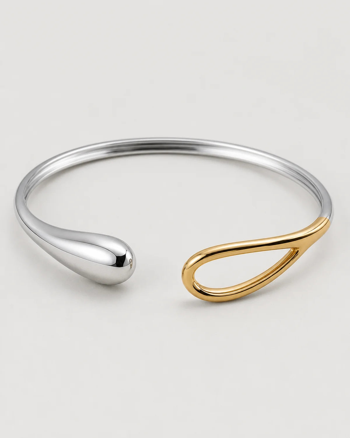 Macro detail of the Sora silver droplet and warm-gold open-loop terminals