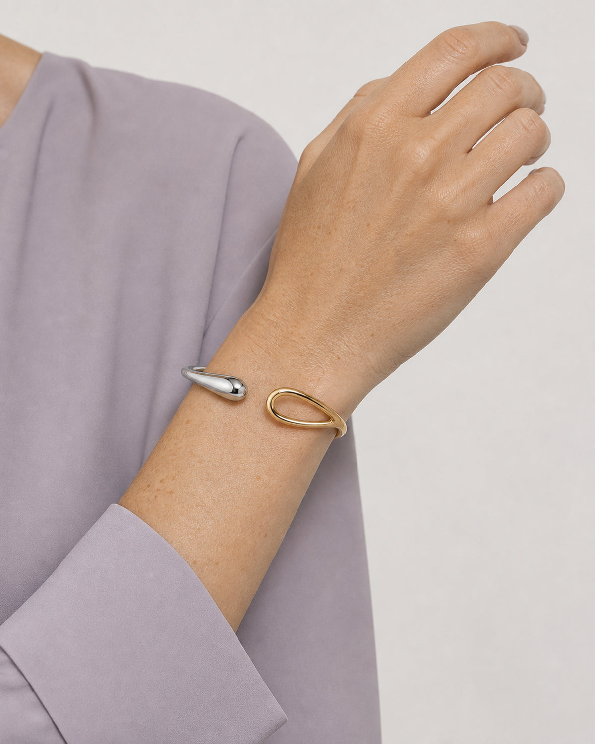 Upright wrist view of Madeleine wearing the Sora two-tone open bangle