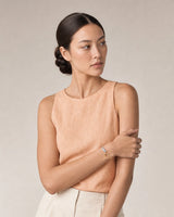 Model in peach and ecru summer linen wearing the Sora two-tone open bangle