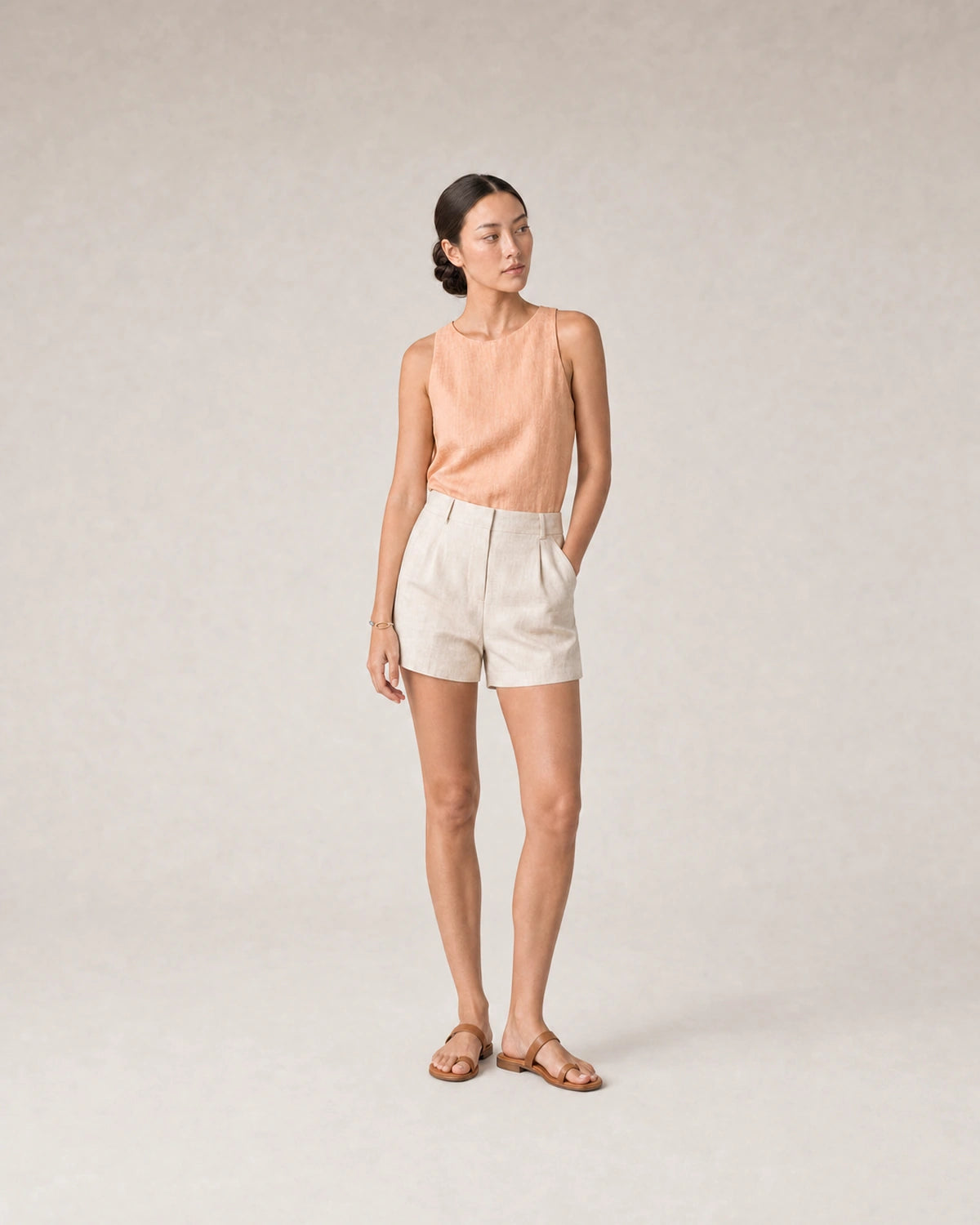 Full-body peach linen summer portrait featuring the Sora bangle