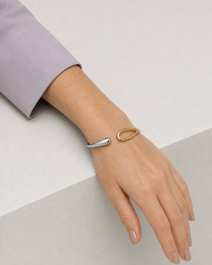Resting forearm view of the Sora two-tone bangle with a muted-lilac cuff