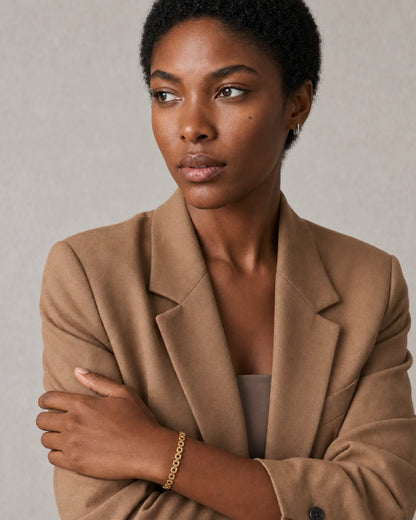 Three-quarter model portrait wearing Talia with a pensive side gaze