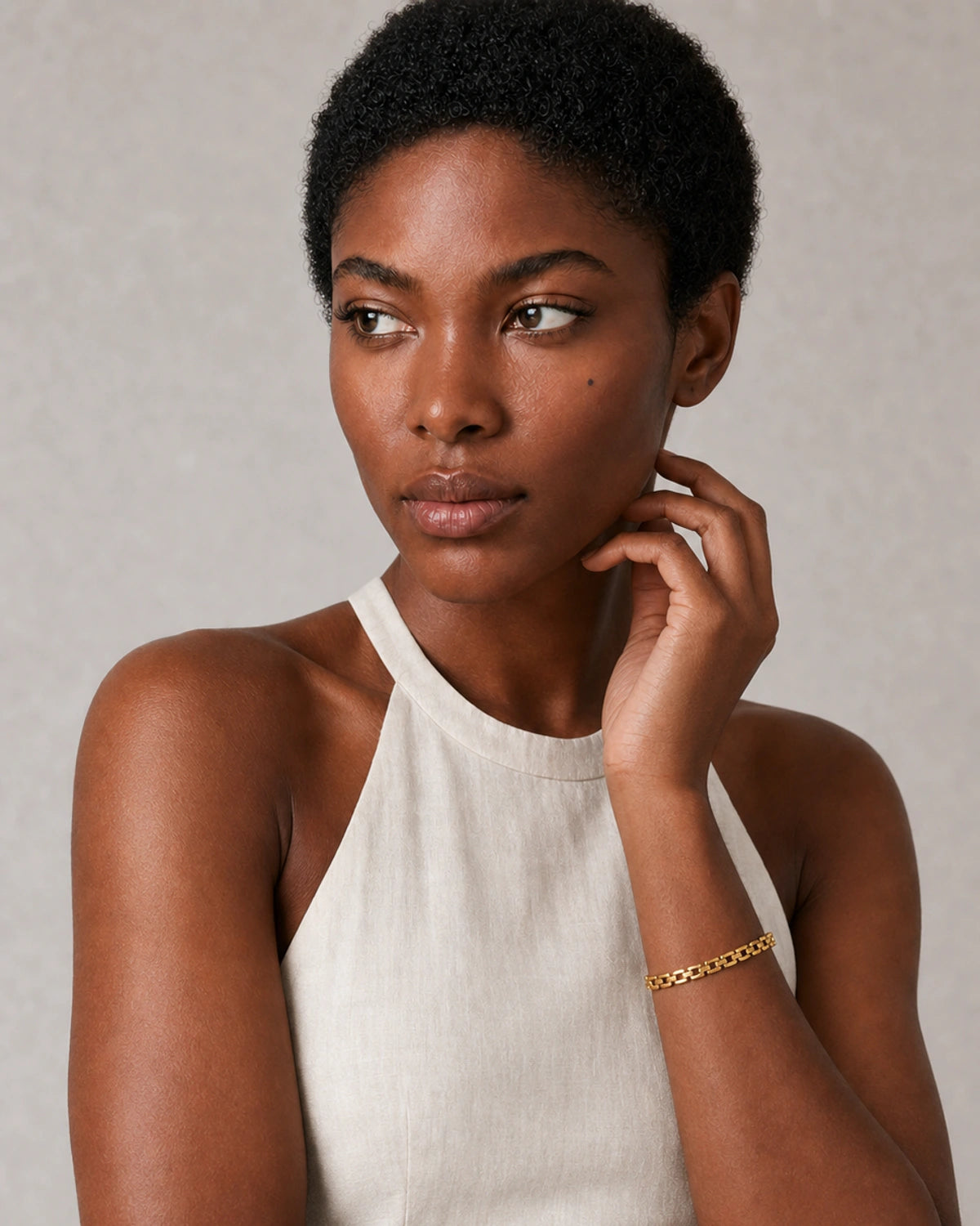 Alternate European-summer portrait featuring the Talia gold timepiece-link bracelet