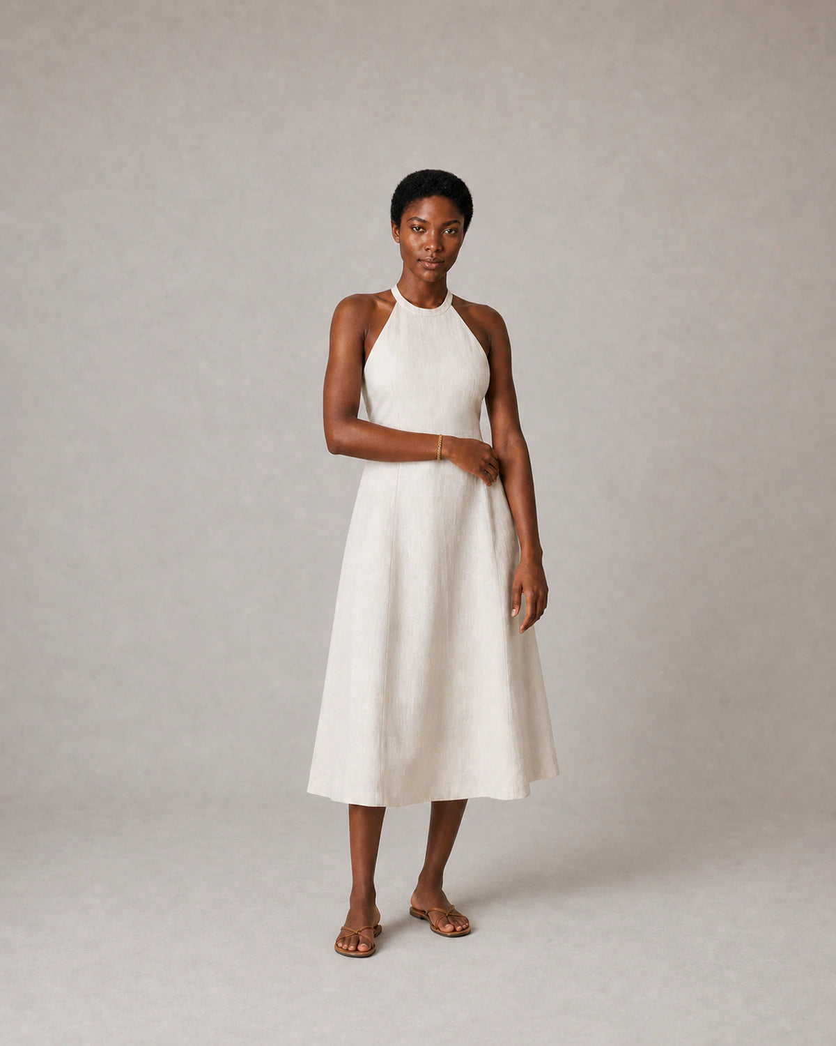 Full-body ivory linen halter portrait featuring the Talia gold bracelet