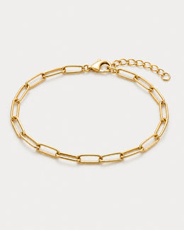 Vela gold paperclip bracelet on pale dove-grey