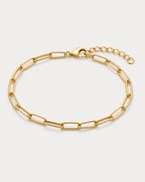 Vela gold paperclip bracelet on pale dove-grey