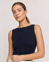 Model in a navy sleeveless Riviera summer top wearing the Vela paperclip bracelet
